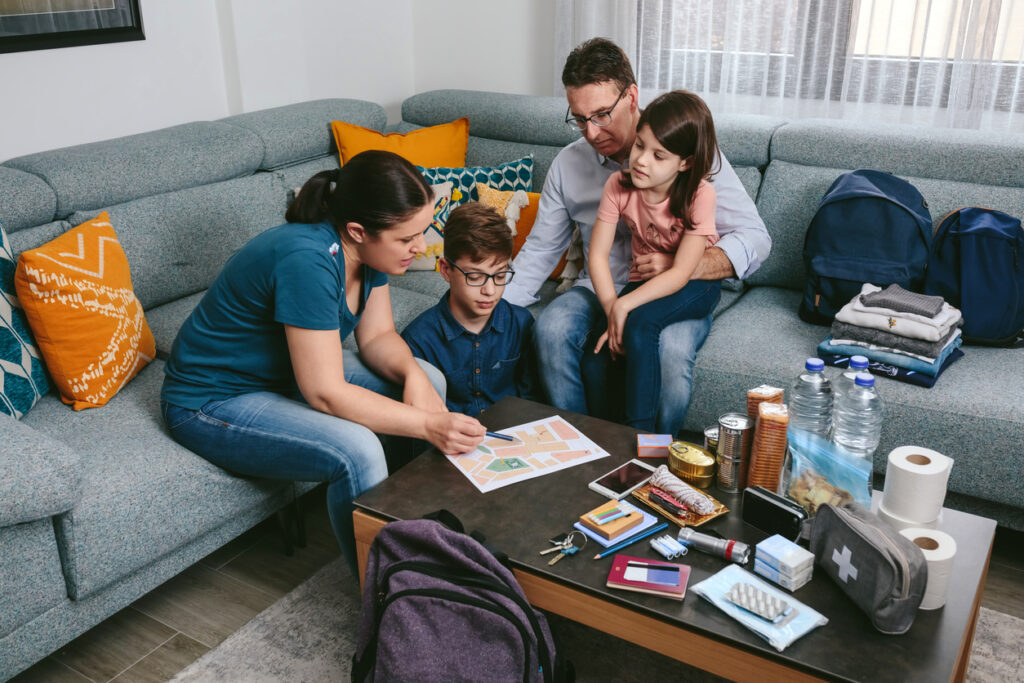 A family sitting on a couch going over an evacuation plan