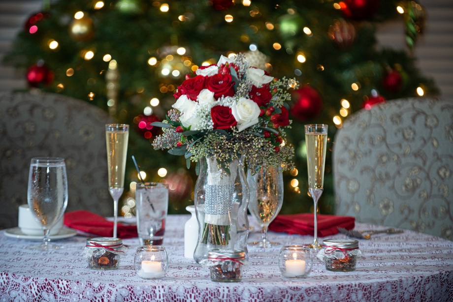 A table with glasses and a vase of flowers 